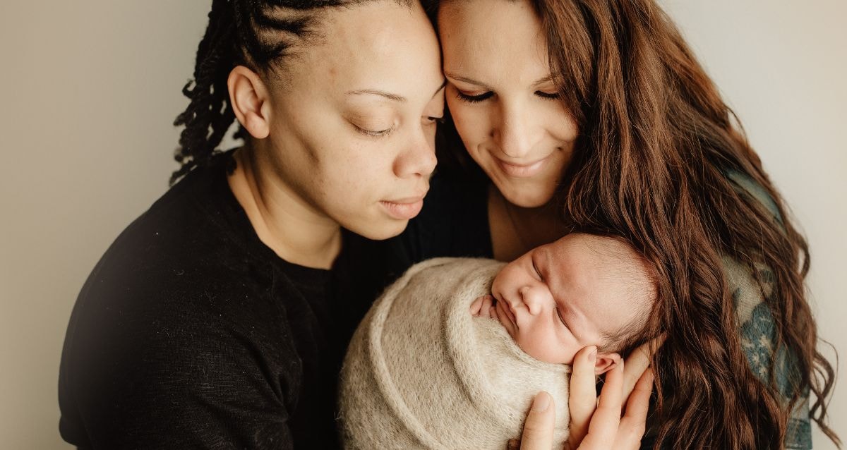 Intended parents with their new baby